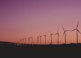 Silhouetted wind turbines at sunset in Zahara de los Atunes, Spain.